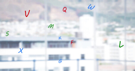 Image of falling letters over cityscape