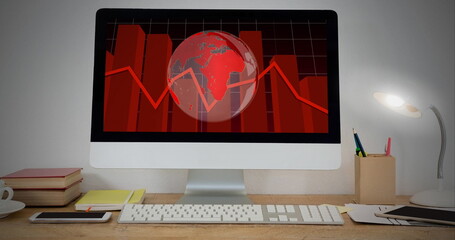 Statistical data processing and spinning globe on computer screen on wooden table