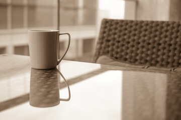 white coffee cup with outdoor view , sepia tone