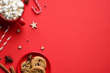 Christmas composition. Cookies, hot chocolate with marshmallows, festive decorations on red...