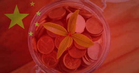 Image of chinese flag waving over plant in jar full of coins
