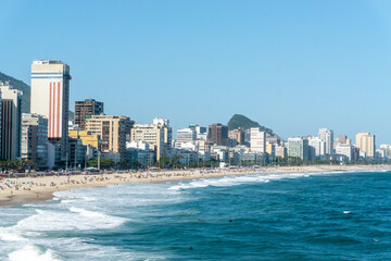 Obraz premium Known for its half-moon-shaped beaches, Copacabana is one of Rio's most lively areas. The sandy beaches and mosaic-tiled promenade attract locals and tourists to enjoy a variety of 24-hour activities.