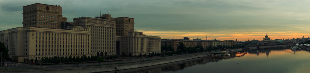 Fototapeta na wymiar Sunrise over Moscow City and Moscow river. Early morning cityscape panorama with Ministry of Defense building on the embankment of Moskva river. Landscape of Moscow downtown