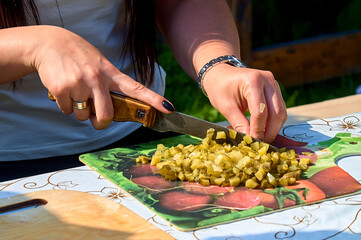 slicing pickles on a cutting board