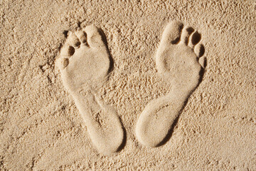 Foot prints in the sand. The concept of travel and vacation by the sea. Foot disease, orthopedic...