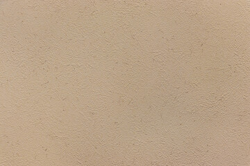 表面に小さな凹凸のあるベージュ色の壁
