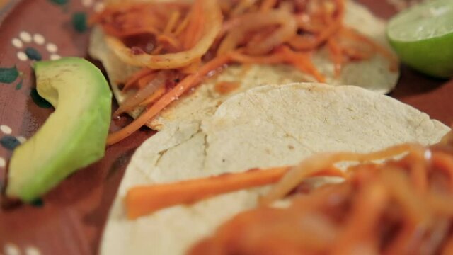 Vegan Mexican tinga tacos on traditional clay plate