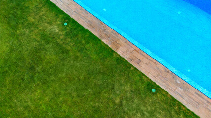 Aerial. Swimming pool fragment in landscape design. View above from drone.