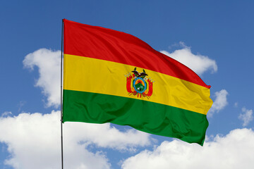 Bolivia flag isolated on the blue sky background. close up waving flag of Bolivia. flag symbols of Bolivia. Concept of Bolivia.