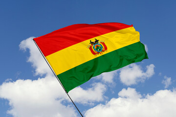 Bolivia flag isolated on the blue sky background. close up waving flag of Bolivia. flag symbols of Bolivia. Concept of Bolivia.