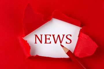 NEWS text on the red torn paper with red pencil