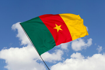 Cameroon flag isolated on the blue sky background. close up waving flag of Cameroon. flag symbols of Cameroon. Concept of Cameroon.