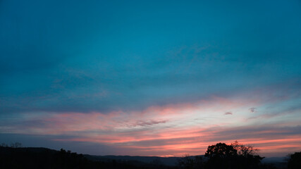 Obraz na płótnie Canvas Landscape of beautiful twilight sky behind woods.