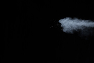 White powder explosion on black background. Colored cloud. Colorful dust explode. Paint Holi.
