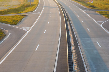 Photo of a gray road with white road markings