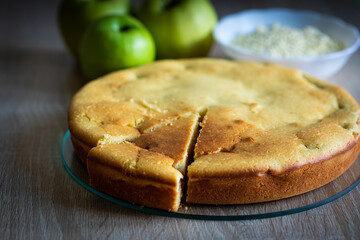 Still life with apple pie made of corn flour on wooden table