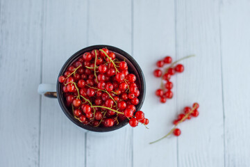 Red currant berries in a white cup