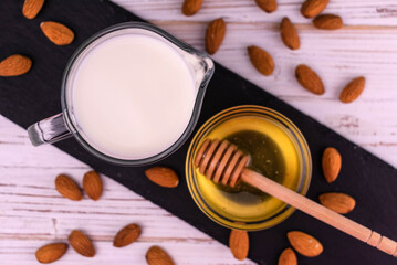 Almond milk and fresh honey. View from above.