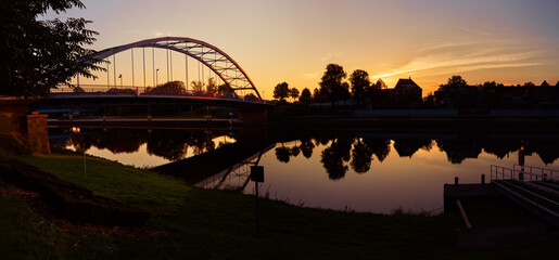 scenic sunset panorama of the bridge over the river Weser in Hoya (Germany)