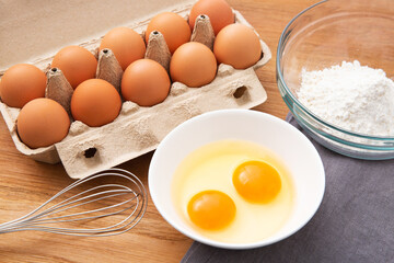 eggs in box and flour on the wooden table