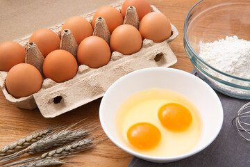 eggs in box and flour on the wooden table