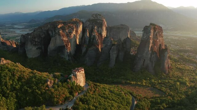 Mountain monastery n Meteora at sunset aerial view. Greece.