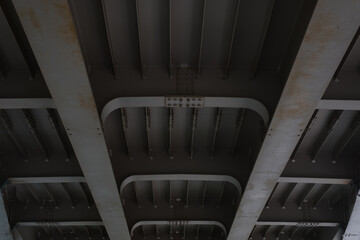 Closeup building structure of modern iron bridge, bottom view. Perspective, selective focus
