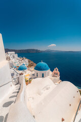 Blue dome and white Church bell tower in the village of Oia in Santorini, Greece