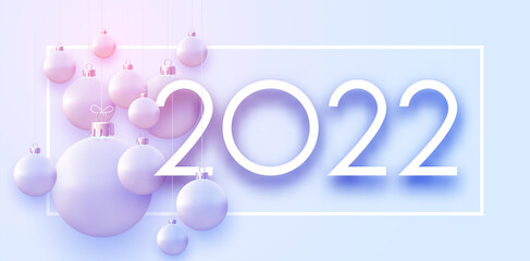 2022 sign with hanging beautiful Christmas baubles.