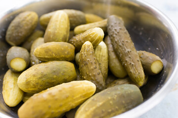 Appetizing pickles in a metal container. Pickled cucumbers.