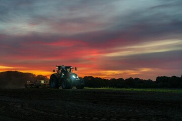 Fototapeta premium tractor at sunset