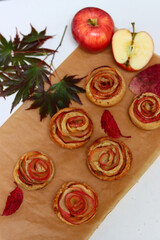 Apple cakes on a table. Close up photo of sweet homemade tarts with cinnamon, honey and apple filling. Autumn desserts ideas. 