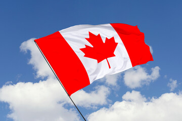 Canada flag isolated on the blue sky background. close up waving flag of Canada. flag symbols of Canada. Concept of Canada.