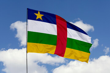 Central African flag isolated on the blue sky background. close up waving flag of Central African. flag symbols of Central African. Concept of Central African.