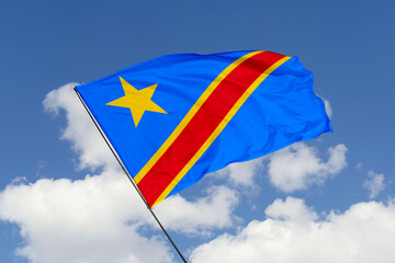 Congo flag isolated on the blue sky background. close up waving flag of Congo. flag symbols of Congo. Concept of Congo.