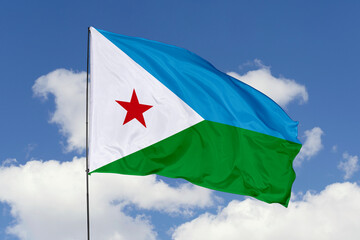 Djibouti flag isolated on the blue sky background. close up waving flag of Djibouti. flag symbols of Djibouti. Concept of Djibouti.