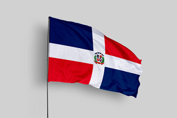 Dominican Republic flag isolated on the blue sky background. close up waving flag of Dominican Republic. flag symbols of Dominican Republic. Concept of Dominican Republic.