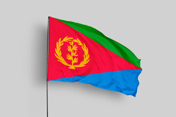 Eritrea flag isolated on the blue sky background. close up waving flag of Eritrea. flag symbols of Eritrea. Concept of Eritrea.