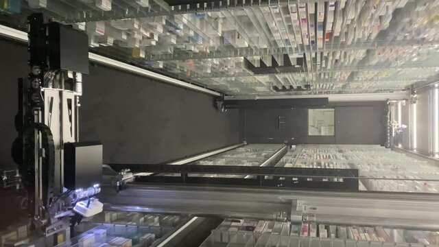 15/10/21-Rome-Italy. Vertical video of automatic pick and place robot for pharmacy warehouse applications. Pharmaceutical Robot Dispenser for pharmacy