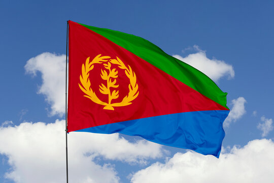 Eritrea flag isolated on the blue sky background. close up waving flag of Eritrea. flag symbols of Eritrea. Concept of Eritrea.