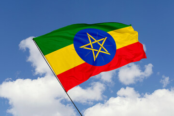 Ethiopia flag isolated on the blue sky background. close up waving flag of Ethiopia. flag symbols of Ethiopia. Concept of Ethiopia.