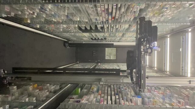 15/10/21-Rome-Italy. Vertical video of automatic pick and place robot for pharmacy warehouse applications. Pharmaceutical Robot Dispenser for pharmacy