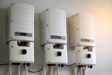Photovoltaic power converter system unit installed on wall. Electrical converter converts  direct...