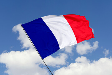 Naklejka na ściany i meble France flag isolated on the blue sky background. close up waving flag of France. flag symbols of France. Concept of France.