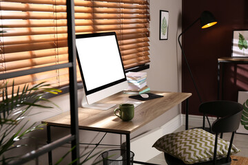 Comfortable workplace with modern computer and stylish furniture in room. Interior design