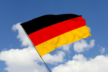 Germany flag isolated on the blue sky background. close up waving flag of Germany. flag symbols of Germany. Concept of Germany.
