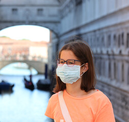 girl with surgical mask and glasses on the island of venice in northern Italy