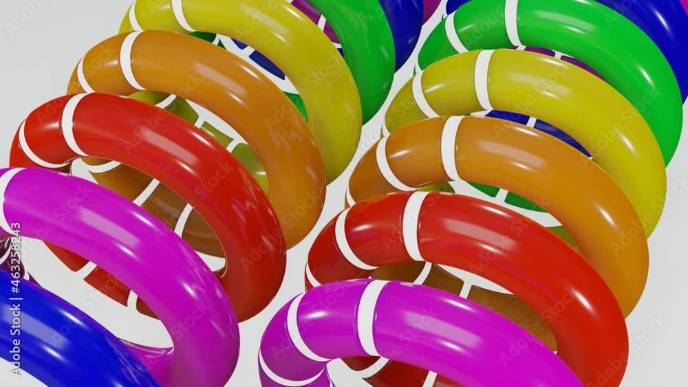 Poster rows of multicolored smooth rainbow rings with white cutouts rotate slowly against a white backgroun