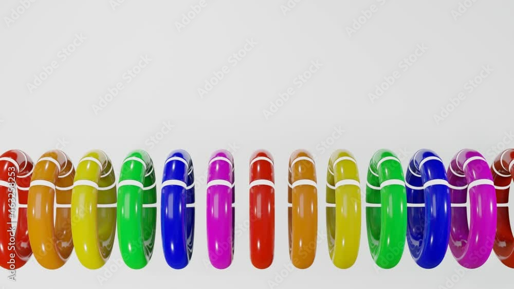 Poster rows of multicolored smooth rainbow rings with white cutouts rotate slowly against a white backgroun