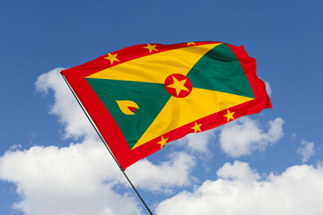 Grenada flag isolated on the blue sky background. close up waving flag of Grenada. flag symbols of Grenada. Concept of Grenada.